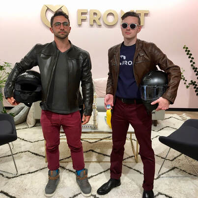 Mark and a friend holding motorcycle helmets